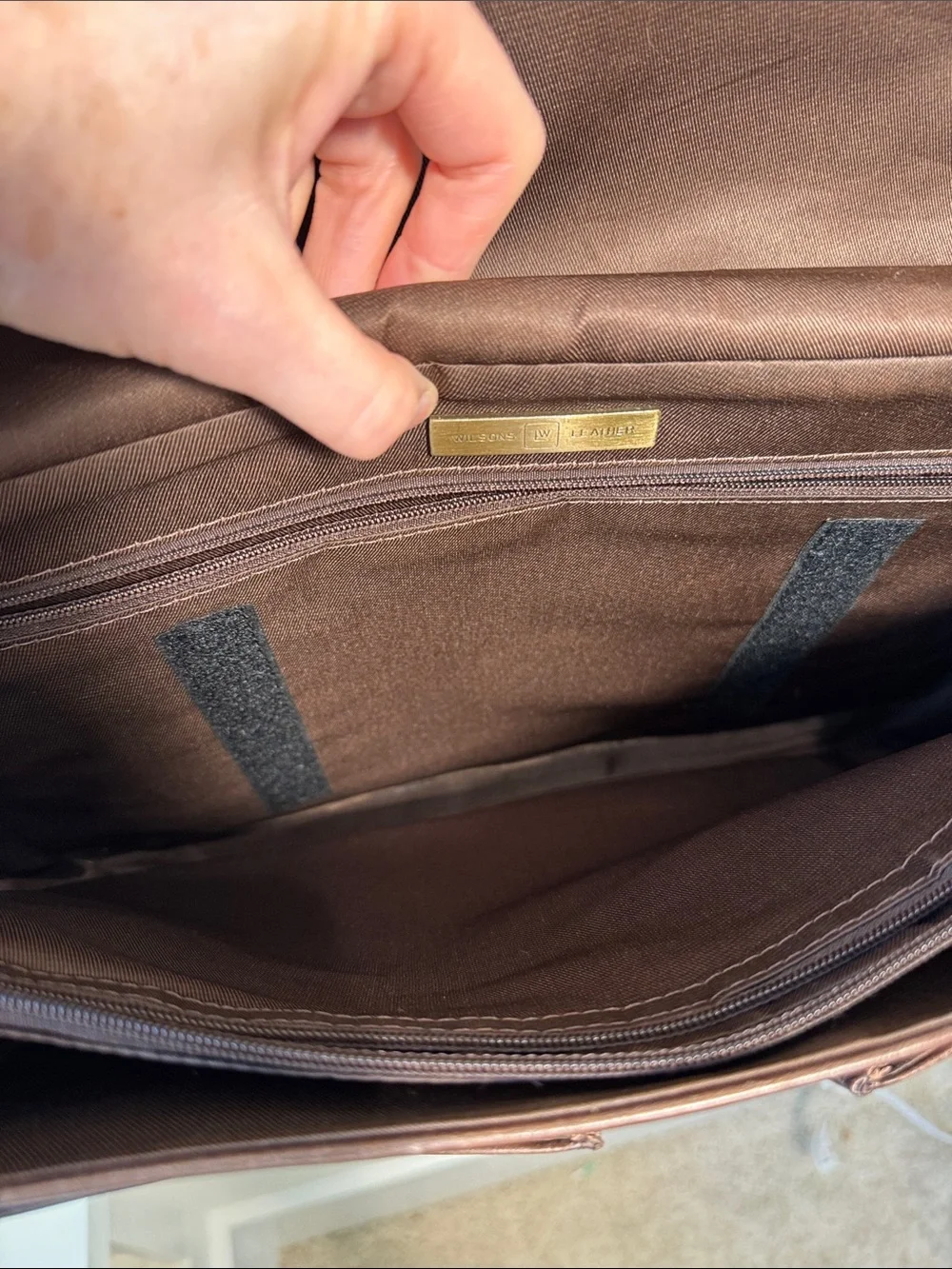 Wilson’s Leather chocolate brown messenger bag with webbed adjustable strap.